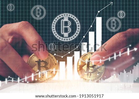 Golden Bitcoin in a businessman hand with trading graphic, Digital symbol of a new virtual currency, online marketing business world trend, money coin economy block chain transfers concept