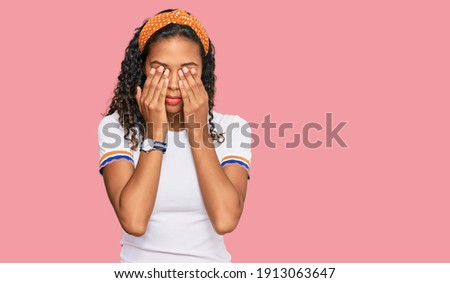 Young african american girl wearing casual clothes rubbing eyes for fatigue and headache, sleepy and tired expression. vision problem 