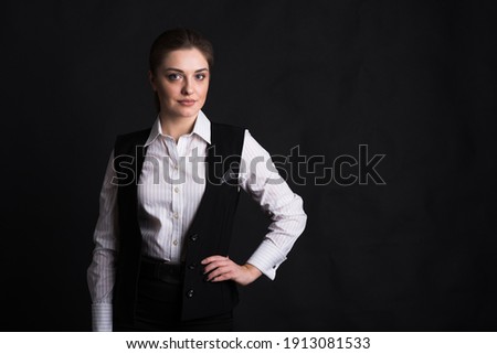 Portrait of a female business lady in the studio on a black background with copyspace