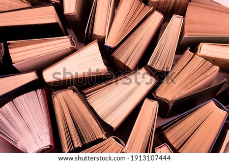 Book background. Old books in the library. Bookshelf shop. Knowledge publications, literature. Bookish bookstore, bookshop. Flatlay top view. Peach fuzz color Royalty-Free Stock Photo #1913107444