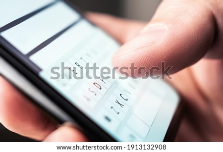 Text message with smartphone. Man texting sms with phone. Catfish or mobile scam. Digital instant messaging chat. Macro close up of keyboard and finger writing. Conversation with girlfriend or friend. Royalty-Free Stock Photo #1913132908