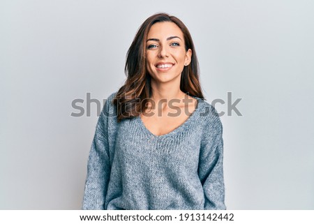 Young brunette woman wearing casual winter sweater with a happy and cool smile on face. lucky person.  Royalty-Free Stock Photo #1913142442