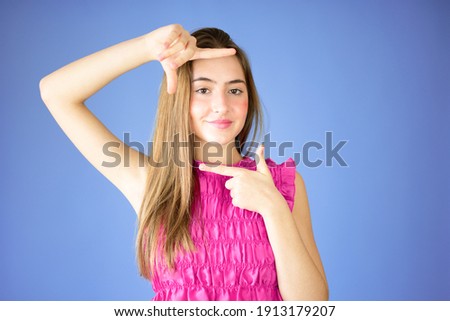 Beautiful young girl frame gesture over lilac background.
