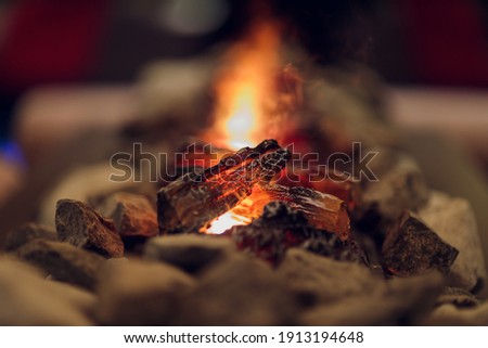 Close up of electric fireplace with orange and yellow fire flame.