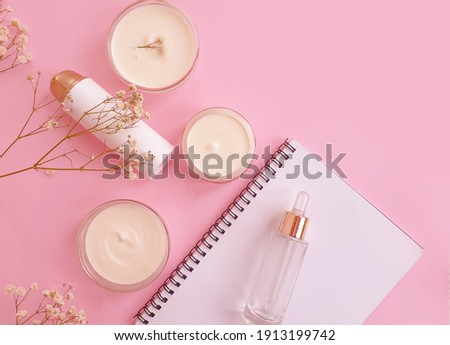 cream cosmetic rose flower on colored background