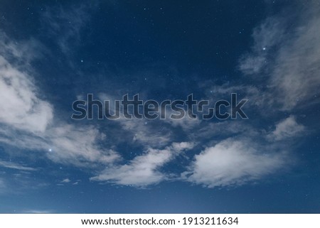 Starry night sky with clouds