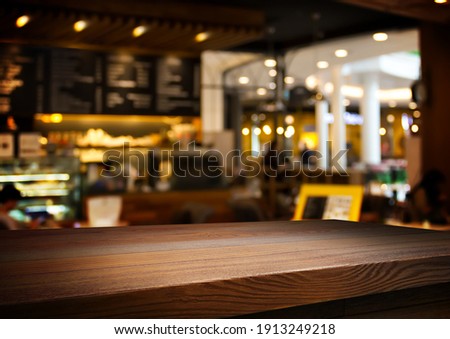 wooden table for placing products with a beautiful night restaurant backdrop, Space for placing items on the table, product and food display.