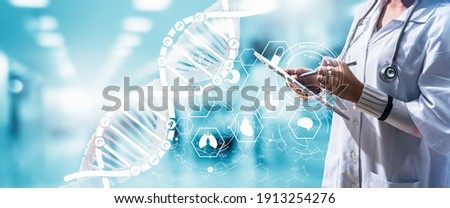 Doctor or Surgeon analyzing covid-19 to patient lungs testing result and human anatomy on technological digital futuristic virtual interface.Doctor with virtual reality in operation room in hospital. Royalty-Free Stock Photo #1913254276