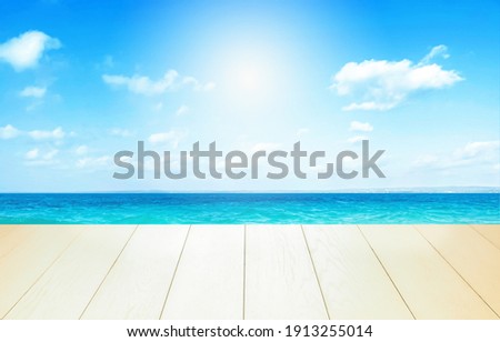 Beautiful beach with white sand in sunny summer day. Turquoise ocean water and blue sky with clouds . Natural background for summer vacation, soft focus, space for text