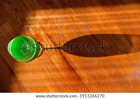 Happy St Patrick's Day concept. Glass of green beer on wooden background close up. Greeting card. Copy space. Top view. 