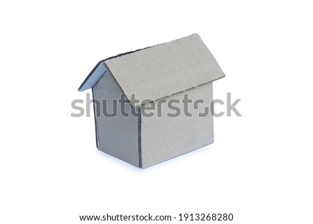 Selective focus of cardboard home isolated on a white background.