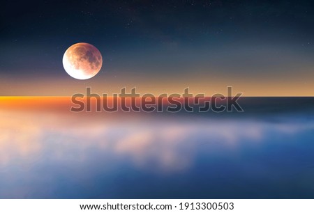 full moon on sunset at sea  cloudy fluffy  blue starry sky  reflection on sea water  