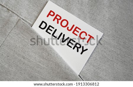 PROJECT DELIVERY text on the white sticker in the shirt pocket.