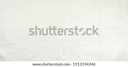 White woven plastic bag texture background.  Polypropylene sack cloth surface. Royalty-Free Stock Photo #1913334346