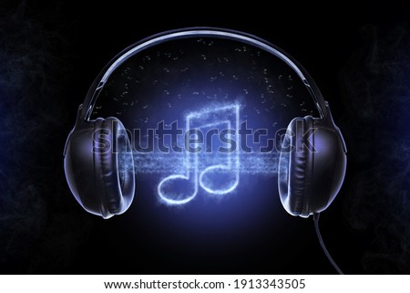 Black musical headphones, and also musical notes shrouded in a mysterious fog with bluish glowing
