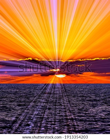 Sun Rays Emanate From Behind the Clouds as the Sun Sets on the Ocean Horizon Royalty-Free Stock Photo #1913354203
