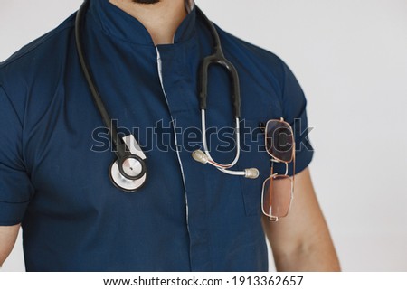 International medical student. Man in a blue uniform. Doctor with stethoscope.