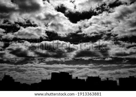 Dramatic skyline with dark sky and airplane and clouds