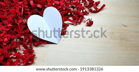 Valentine's Day.  Happy Valentine's Day card.  Red paper filler. Wood background. Blank for a postcard.