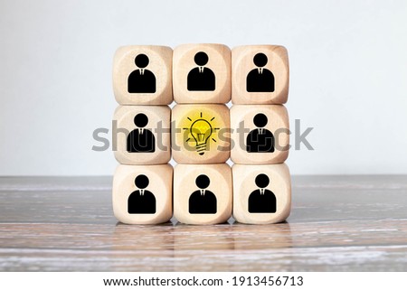 Concept creative idea and innovation. Wooden cube block flip over with head human symbol and light bulb icon