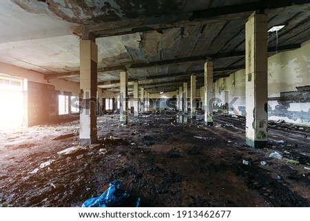 Old broken empty abandoned industrial building interior. Royalty-Free Stock Photo #1913462677