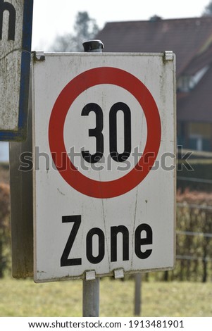 30 kilometers per hour speed limit sign on the street