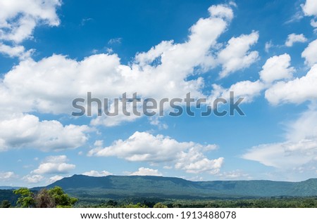 View point of the sandstone mountain range in the national park, rainforest around the mountain, morning time with the cloudy blue sky, front view with the copy space. 