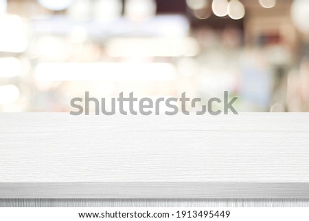 White table presentation, desk and blur background, Empty wood counter, shelf surface over blur restaurant white bokeh background, Wood table top for retail shop, store product display banner, mock up