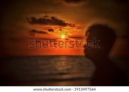 blurred image of people with sunset background