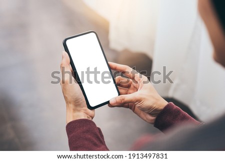 cell phone blank white screen mockup.woman hand holding texting using mobile on desk at office.background empty space for advertise.work people contact marketing business,technology Royalty-Free Stock Photo #1913497831