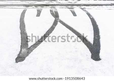 Heart-shaped tire marks on the snow