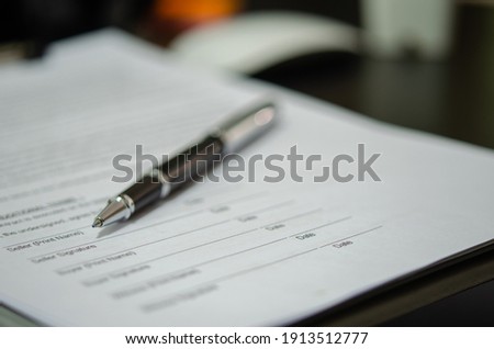 Business pen on paper documents signed.