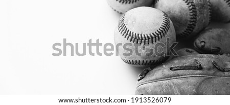 Old black and white baseball equipment from game with texture of balls on banner background.