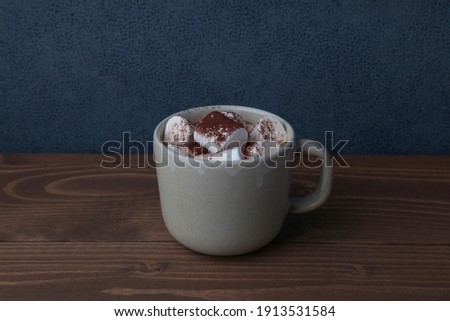 hot chocolate with marshmallows isolated on wooden table