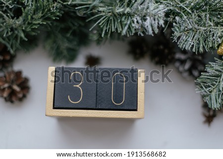 Wooden cubes with date on white background.The thirtieth day of the winter month, a calendar for the workplace. Age.
