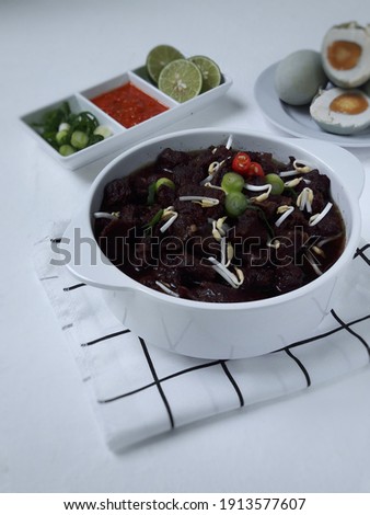 selective focus, grunge textured. a view rawon is traditional indonesia dish, in the form of black soup with a mix special spices using kluwak.
