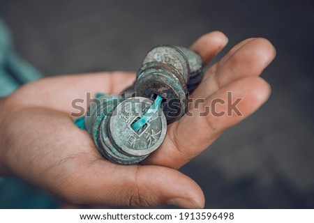 Ancient Chinese coinage, this thought to have originated from the XV century Ming Dynasty (when the trade to Malacca and Java), the coins are commonly found on the of Java around the Borobudur temple. Royalty-Free Stock Photo #1913596498