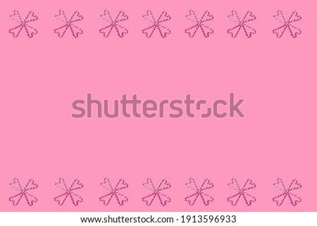 Arrangement of eight candy canes forming four hearts creating windmill. Flat lay on splendid pink background.