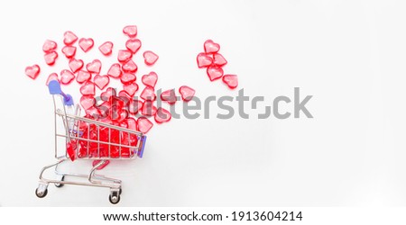 Valentine's day, endless love or special occasion concept : Top view of red hearts spilled out of a shopping cart. isolated on white background. copy space.