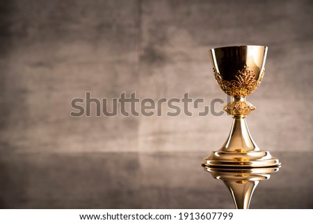 Catholic religion concept. Christianity symbols on gray stone background. Royalty-Free Stock Photo #1913607799