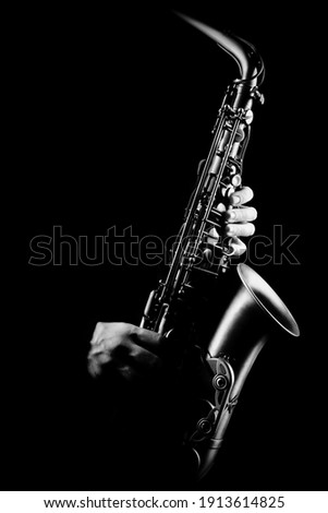 Saxophone player. Saxophonist with alto sax closeup isolated on black. Jazz music instrumens Royalty-Free Stock Photo #1913614825