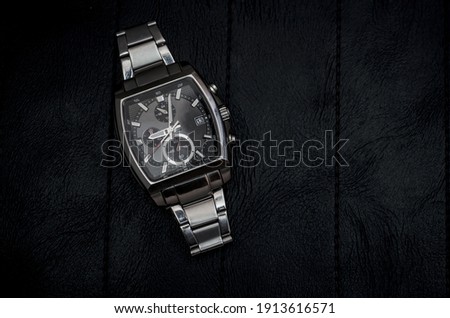 Metal wrist watch on black background. Stock Photo