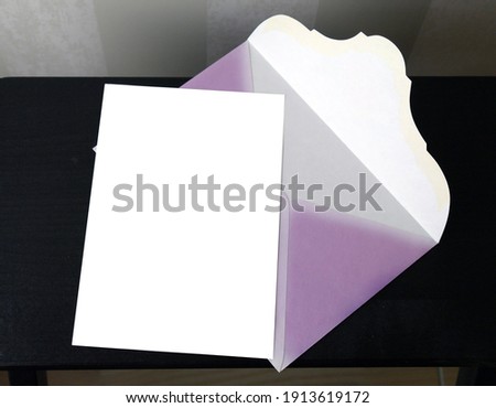 postcard and pink envelope on a dark background for mockup, selective focus. High quality photo