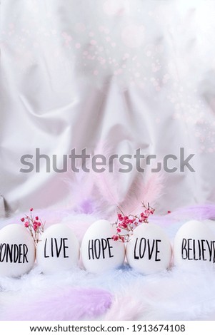 Easter DIY. Do it yourself. Trendy Easter Eggs Composition. Egg name settings. Words drawn with pen. High Angle View Of Shells On Table. Pastel colors. Love Live Believe Wonder Hope