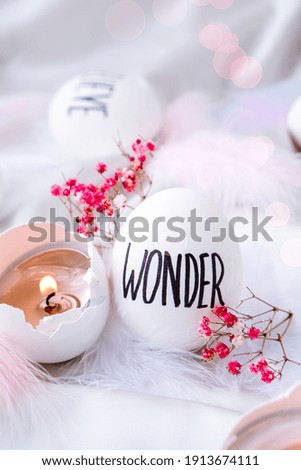 Easter DIY. Do it yourself. Trendy Easter eggs Composition. Easter message, Words drawn with pen. High Angle View Of Shells On Table. Wonder. Candle in egg shell. Candle light Pastel colors.