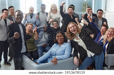 happy team of diverse corporate employees in the office lobby. Royalty-Free Stock Photo #1913678119