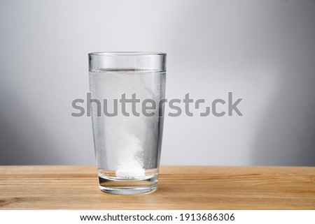 Effervescent tablet dissolved in a glass of water