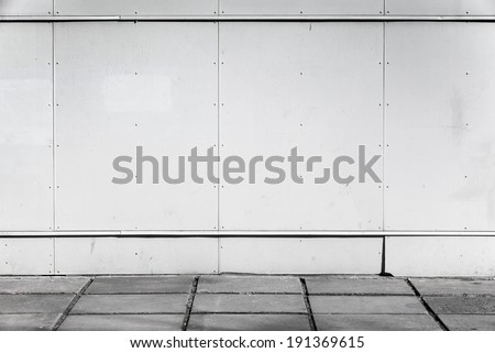 Urban background interior with white metal wall and concrete pavement