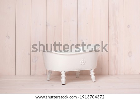 One year old girl or boy make a photoset, backdrop for photographer, holiday decor, diy idea. Photo zone, bath on a wooden background. Bathroom. 