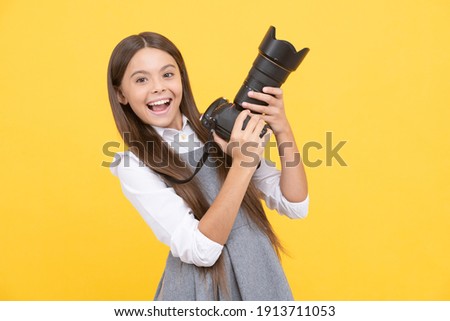 pure happiness. hobby or career. photographer beginner with modern camera. making video. childhood. teen girl taking photo. kid use digital camera. happy child photographing. school of photography. Royalty-Free Stock Photo #1913711053